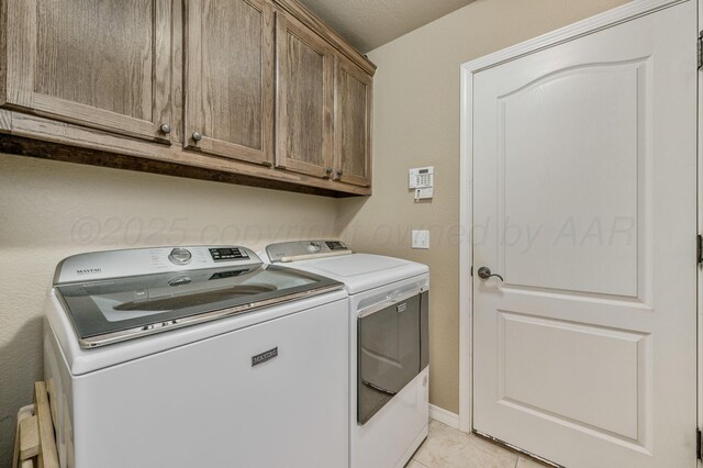 9315 Shylana Ave, Amarillo, TX 79119 - laundry room with cabinet space, independent washer and dryer, and light tile patterned floors