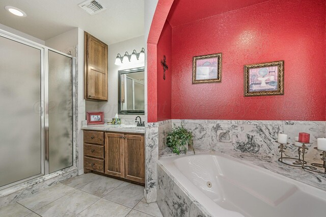 9315 Shylana Ave, Amarillo, TX 79119 - full bath with a stall shower, vanity, a jetted tub, and tile patterned floors