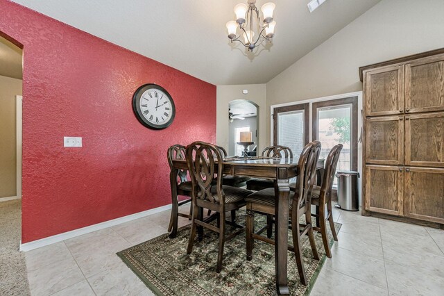 9315 Shylana Ave, Amarillo, TX 79119 - dining area featuring arched walkways, a textured wall, lofted ceiling, a chandelier, and light tile patterned floors