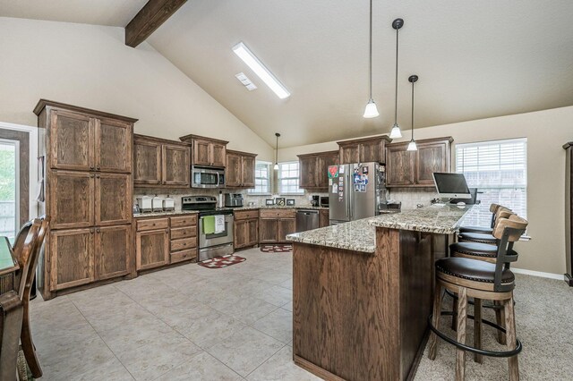 9315 Shylana Ave, Amarillo, TX 79119 - kitchen with appliances with stainless steel finishes, light stone counters, beam ceiling, decorative light fixtures, and backsplash