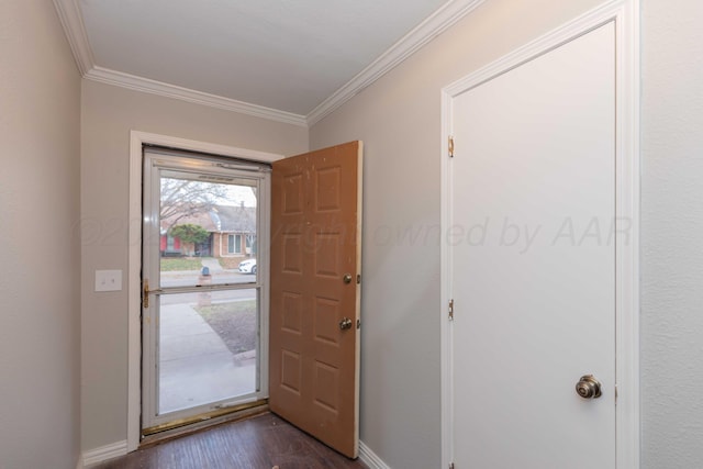 entryway with dark hardwood / wood-style flooring and crown molding