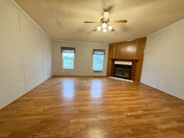 2700 Potter Dr, Amarillo, TX 79108 - unfurnished living room featuring crown molding, a textured ceiling, ceiling fan, and wood finished floors