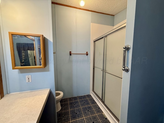2700 Potter Dr, Amarillo, TX 79108 - bathroom with vanity, a shower stall, toilet, and a textured ceiling