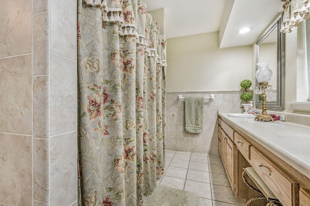 2229 Charles St, Pampa, TX 79065 - full bathroom featuring vanity, tile walls, tile patterned flooring, wainscoting, and a shower with curtain