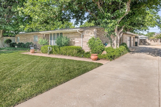 2229 Charles St, Pampa, TX 79065 - view of front facade featuring driveway, a garage, and stone siding
