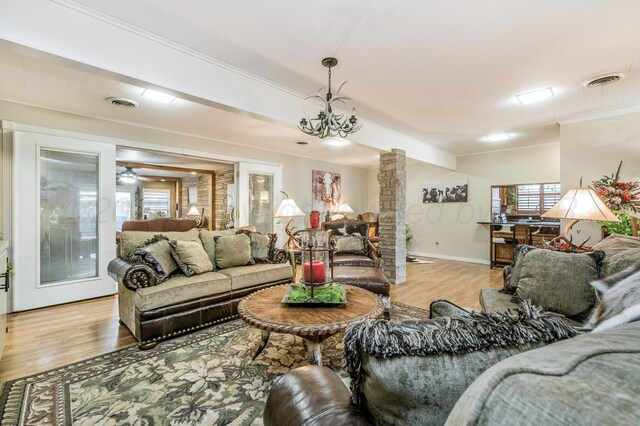 2229 Charles St, Pampa, TX 79065 - living room featuring ornate columns, light wood-style flooring, and ornamental molding