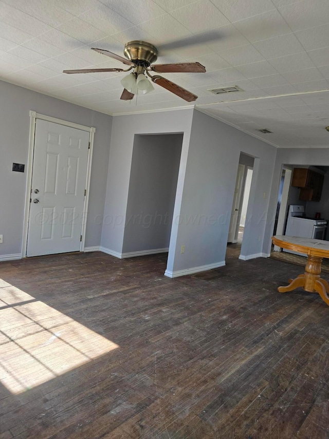 unfurnished living room featuring washer / dryer, dark hardwood / wood-style floors, and ceiling fan