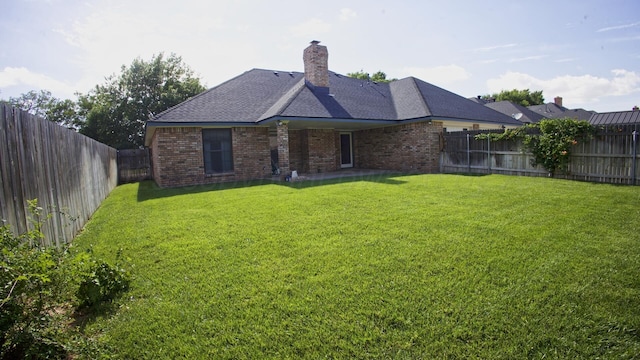 8107 Progress Dr, Amarillo, TX 79119 - back of house featuring brick siding, a fenced backyard, and a chimney