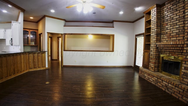 8107 Progress Dr, Amarillo, TX 79119 - unfurnished living room featuring ceiling fan, ornamental molding, dark wood-style flooring, a fireplace, and recessed lighting