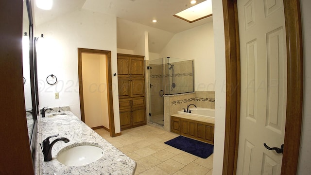 8107 Progress Dr, Amarillo, TX 79119 - full bath featuring vaulted ceiling, a stall shower, a garden tub, double vanity, and a skylight