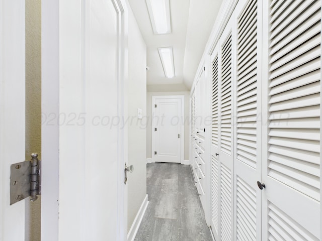 hall with wood finished floors and baseboards