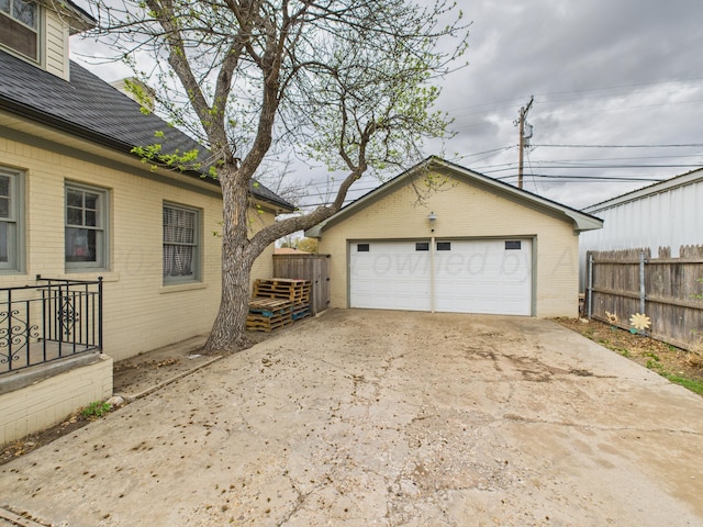 detached garage featuring fence