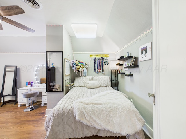 bedroom featuring visible vents and wood finished floors
