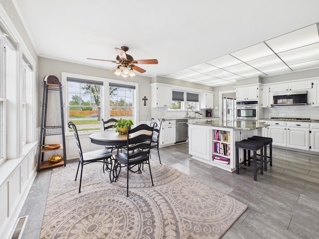 dining area with ceiling fan and visible vents