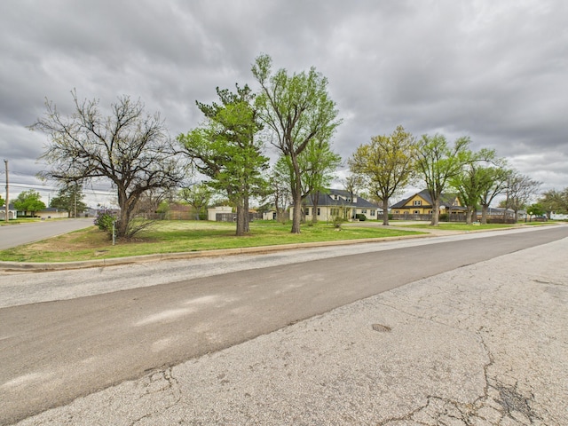 view of street featuring a residential view and curbs