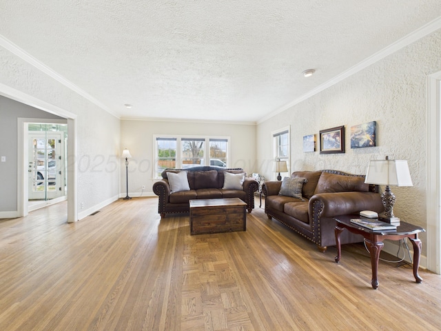 living room with ornamental molding, light wood finished floors, and a textured ceiling