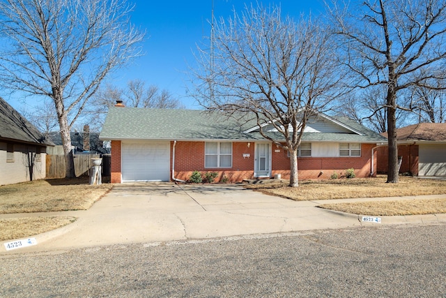 ranch-style house with brick siding, roof with shingles, fence, a garage, and driveway