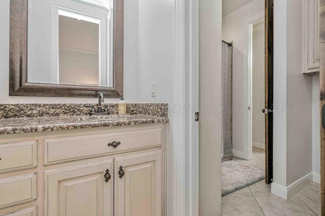 bathroom with vanity, a shower with curtain, and baseboards