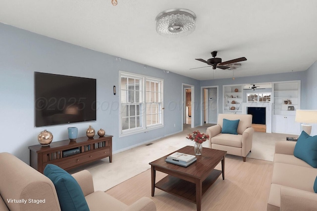 1338 Haggard St, Borger, TX 79007 - living area with ceiling fan, baseboards, and built in shelves