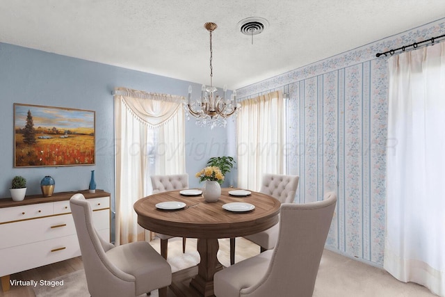 1338 Haggard St, Borger, TX 79007 - dining room featuring a chandelier, a textured ceiling, and visible vents