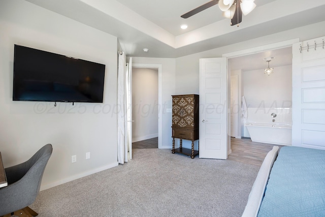 bedroom featuring baseboards, a raised ceiling, carpet flooring, and a ceiling fan
