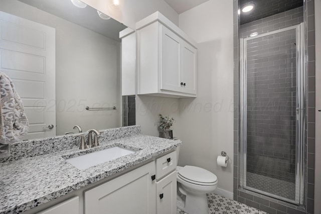 full bath featuring a shower stall, vanity, and toilet