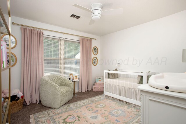 7133 Birkshire Dr, Amarillo, TX 79109 - bedroom with light colored carpet, a sink, a ceiling fan, and a crib