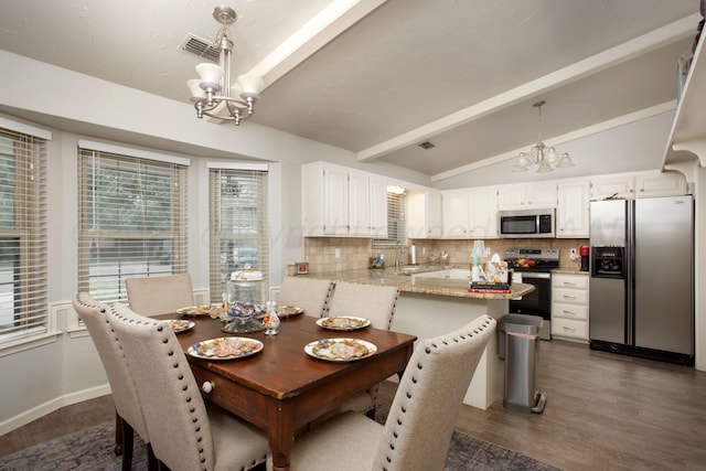 7133 Birkshire Dr, Amarillo, TX 79109 - dining space with a chandelier, dark wood finished floors, and baseboards