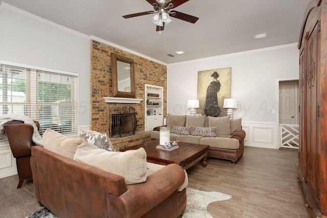 7133 Birkshire Dr, Amarillo, TX 79109 - living room with ornamental molding, a ceiling fan, a fireplace, wood finished floors, and a wainscoted wall
