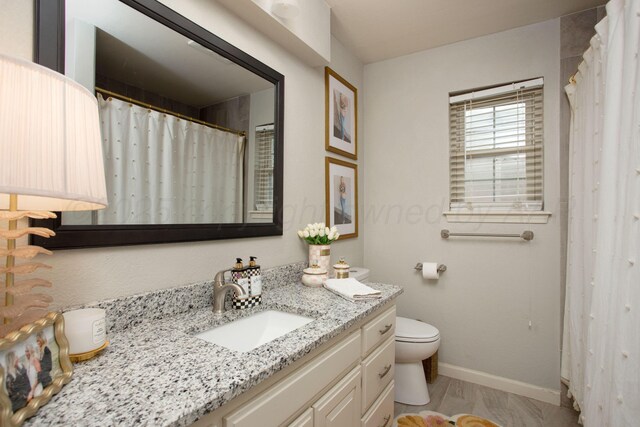 7133 Birkshire Dr, Amarillo, TX 79109 - bathroom with toilet, vanity, and baseboards