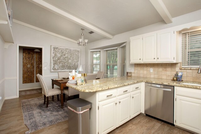 7133 Birkshire Dr, Amarillo, TX 79109 - kitchen with dishwasher, a chandelier, a peninsula, tasteful backsplash, and white cabinetry