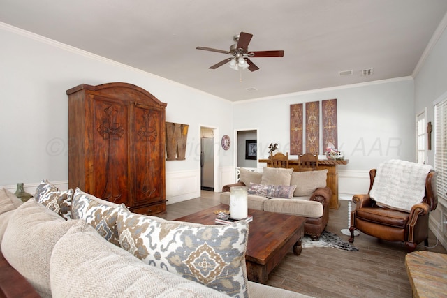 7133 Birkshire Dr, Amarillo, TX 79109 - living room with a ceiling fan, wood finished floors, ornamental molding, a wainscoted wall, and a decorative wall