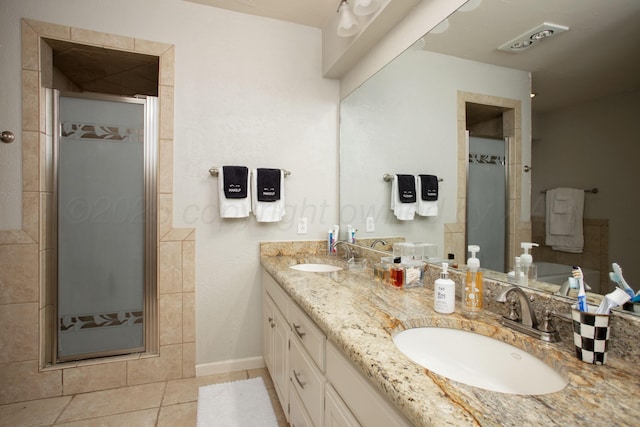 7133 Birkshire Dr, Amarillo, TX 79109 - full bathroom with a stall shower, double vanity, tile patterned flooring, and baseboards