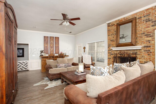 7133 Birkshire Dr, Amarillo, TX 79109 - living room featuring ceiling fan, ornamental molding, wood finished floors, a fireplace, and wainscoting