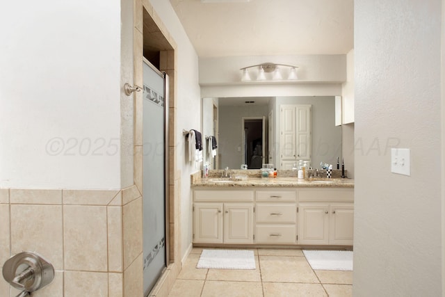 7133 Birkshire Dr, Amarillo, TX 79109 - bathroom featuring double vanity, tile patterned floors, and a shower stall