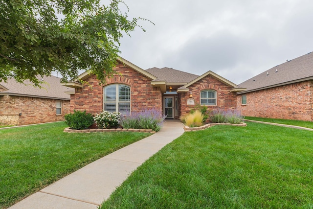 7414 Southbend Dr, Amarillo, TX 79119 - ranch-style home with brick siding, a front lawn, and roof with shingles