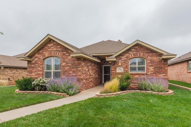 7414 Southbend Dr, Amarillo, TX 79119 - ranch-style home featuring brick siding, roof with shingles, and a front lawn