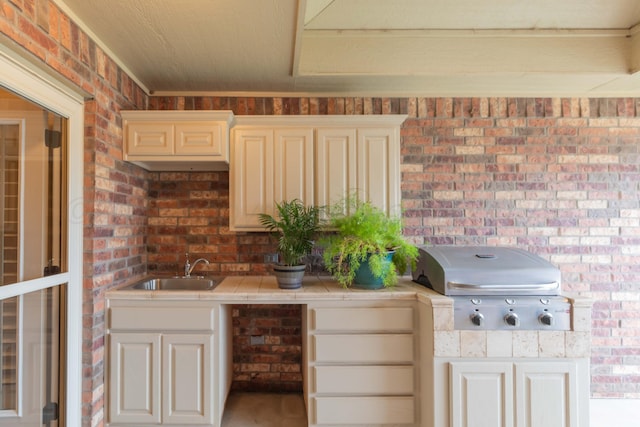 7414 Southbend Dr, Amarillo, TX 79119 - kitchen featuring tile countertops and brick wall