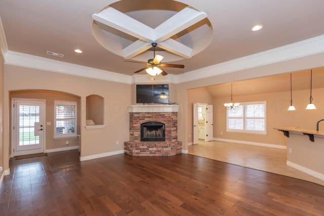7414 Southbend Dr, Amarillo, TX 79119 - unfurnished living room with ornamental molding, a fireplace, a chandelier, a ceiling fan, and wood finished floors