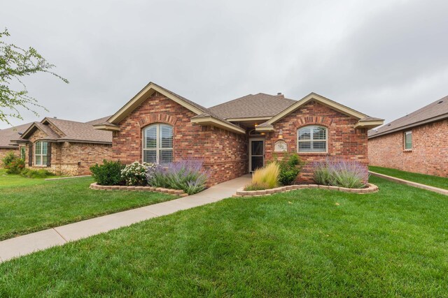 7414 Southbend Dr, Amarillo, TX 79119 - ranch-style house featuring brick siding, a front yard, and roof with shingles