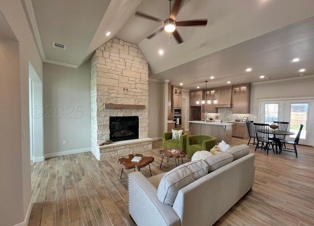 7504 Limestone Dr, Amarillo, TX 79119 - living room featuring ceiling fan, light wood finished floors, ornamental molding, baseboards, and lofted ceiling