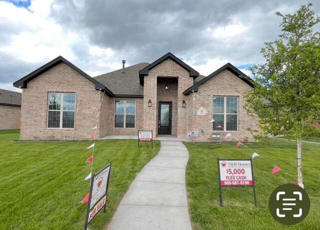 7504 Limestone Dr, Amarillo, TX 79119 - view of front facade featuring brick siding, a front yard, and roof with shingles