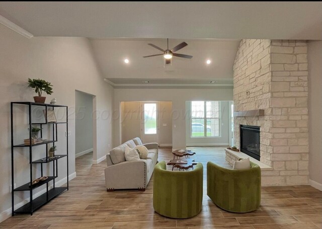 7504 Limestone Dr, Amarillo, TX 79119 - unfurnished living room featuring a sink, vaulted ceiling, ceiling fan, a fireplace, and light wood-style flooring