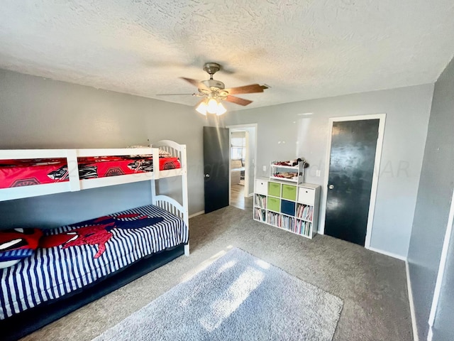 bedroom with baseboards, carpet flooring, a textured ceiling, and ceiling fan