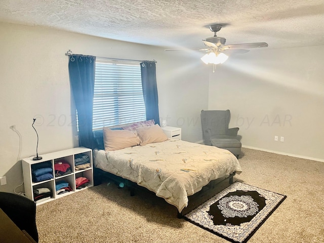 carpeted bedroom with a ceiling fan, baseboards, and a textured ceiling