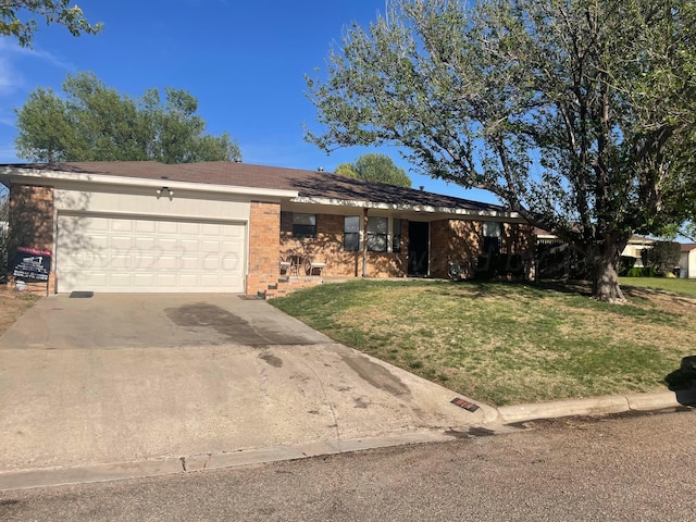 single story home with brick siding, an attached garage, a front lawn, and concrete driveway