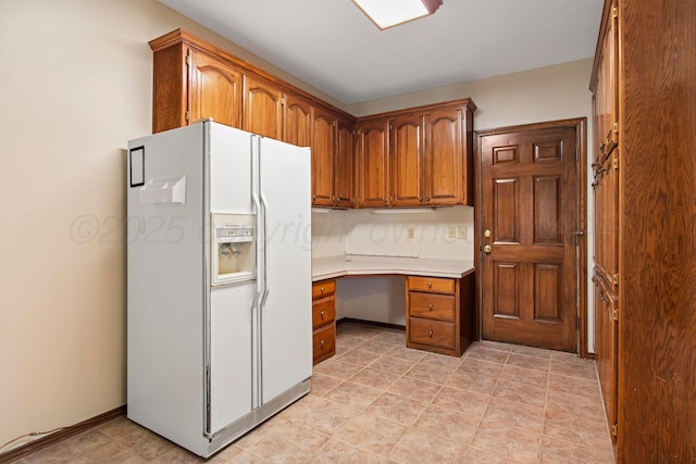 624 Nara Visa Ln, Fritch, TX 79036 - kitchen featuring white fridge with ice dispenser, brown cabinetry, and light countertops