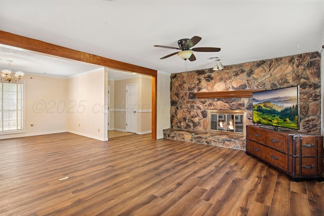 624 Nara Visa Ln, Fritch, TX 79036 - unfurnished living room with ceiling fan, wood finished floors, crown molding, a chandelier, and baseboards