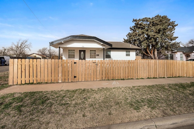 bungalow-style house featuring a fenced front yard