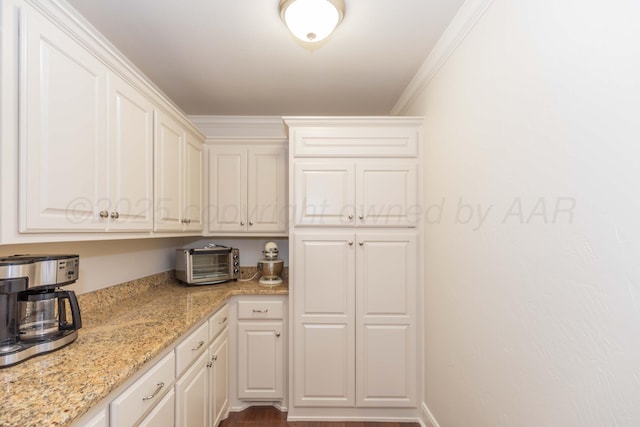 7901 Kingsgate Dr, Amarillo, TX 79119 - kitchen with light stone counters, white cabinets, and ornamental molding